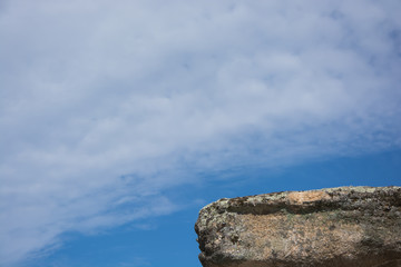stone or platform floating in the blue sky with clouds, copy-space