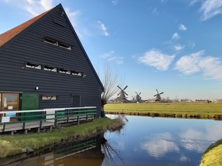 The Dutch Dutch suburb of Zaansche Schans. The water channels, the serene climate and the typical windmills.