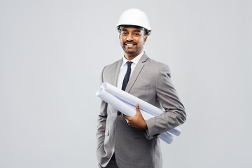 architecture, construction business and people concept - smiling indian male architect in helmet...