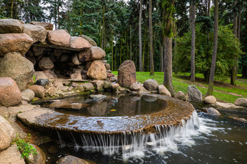 Water Cascade and Small Cave in Park