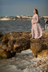 happy pregnant woman at sea at resort. The concept of midwifery.