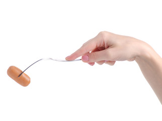 Sausage on fork in hand on white background isolation