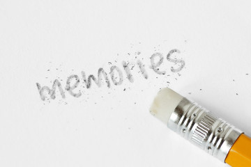 The word memories written with a pencil and erased with rubber - Concept of fading memories
