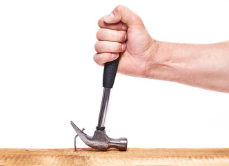 Hand pulls hammer nail out of the Board, on an isolated white background.