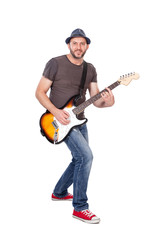 Musician smiling, playing electric guitar with enthusiasm. Isolated on white