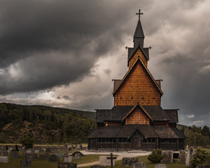 Fototapeta na wymiar Stavkirke in Norway - old church with beautiful sky