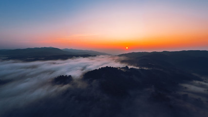 Fototapeta na wymiar Sunrise in the morning mountains and fog
