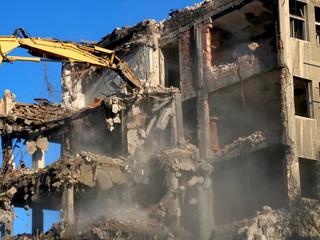 Building demolition with hydraulic excavator