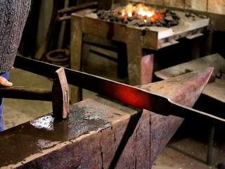 Forging hot iron