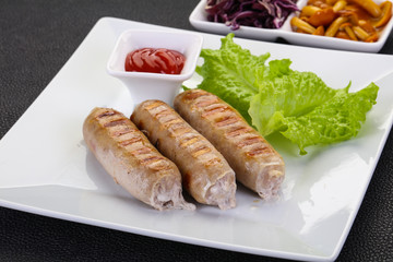 Grilled sausages served mushrooms and cabbage