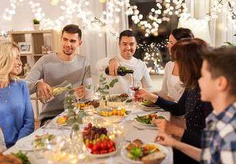 celebration, holidays and people concept - happy family having dinner party at home