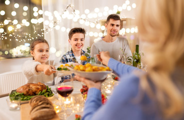 celebration, holidays and people concept - happy family having dinner party at home