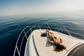 Pretty young woman on the yacht at summer - obrazy, fototapety, plakaty