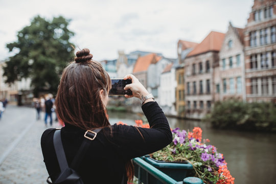 Young woman taking picture in Gent, Belgium 