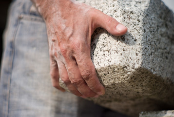 hand holding granite stone
