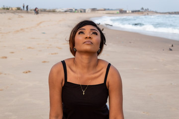 Lady doing a sun salutation yoga pose by the beach