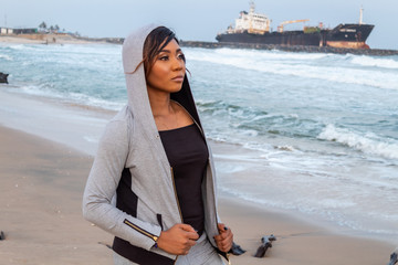 Lady in a hoodie by the beach