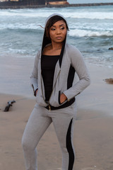 Lady in a hoodie by the beach