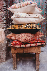 Obraz na płótnie Canvas Close up of cushions in front of old door in Marrakesh, Morocco 