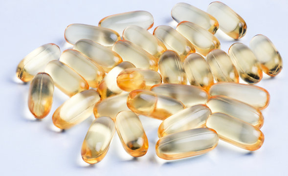 Cod liver oil omega 3 gel capsules isolated on pastel background