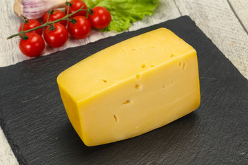 Hard yellow tasty cheese brick