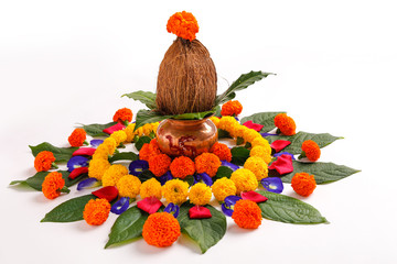 Copper Kalash with coconut , leaf and floral decoration on a white background. essential in hindu...