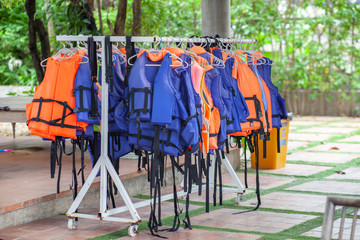 life jacket in colourful color is safety equipment hanging on a clothes line .