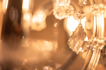 Blurred Background Chrystal chandelier lamp on the ceiling in Dining room Adjusting the image in a Luxury tone . Decorative elegant vintage and Contemporary interior Concept. - obrazy, fototapety, plakaty