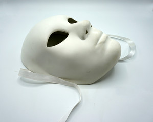 Theater concept. Closeup of white classical theatrical mask on white background.
