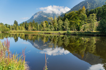 Oberstdorf - View to Lake Moorweiher with Nebelhorn mountain reflected on the water / Bavaria / Germany