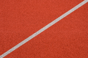 Top view of the running track rubber lanes cover texture with white line marking for background.