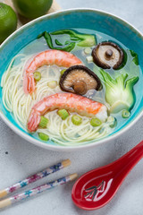 Panasian noodle soup with shrimps, bok choy and shiitake mushrooms, close-up