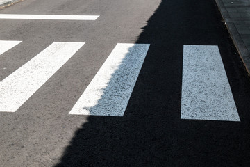 Zebra crossing in a sunshine and shadow