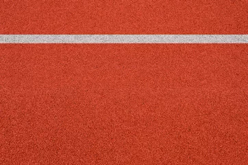 Selbstklebende Fototapeten Top view of the running track rubber lanes cover texture with white line marking for background. © tkroot