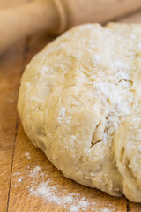 Fresh raw yeast dough with rolling pin