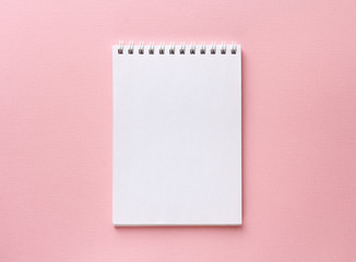open notebook on pastel pink background