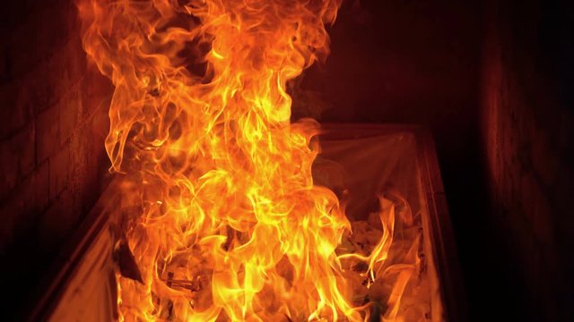 Slow motion fire flame cremate death people burning on dark background.