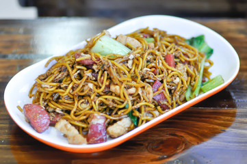 stir-fried noodles with pork, sausage and vegetable
