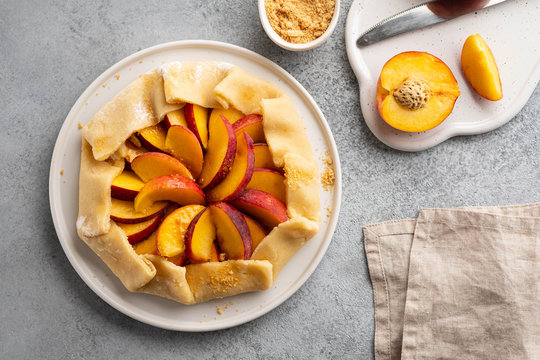 Appetite summer peach galeta on white table with copy space. summer open tart photo for cook book or food blog.