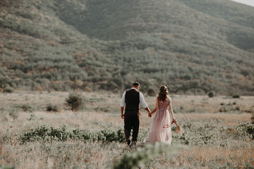 Beautiful wedding couple, bride and groom, in love on the background of mountains