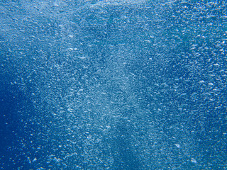 Abstract background of underwater bubbles in the Aponissos beach, Agistri island, Saronic Gulf, Attica, Greece.