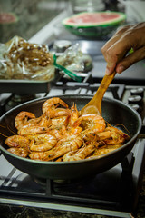 fried shrimp in a pan on a fire