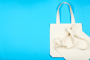 White cotton eco bags on blue background