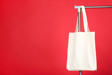 White cotton eco bag hanging on clothes rack