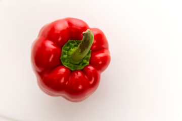 Juicy red bell pepper on a white background. Diet vegetarian food. Top view.