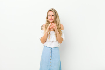 young blonde woman scheming and conspiring, thinking devious tricks and cheats, cunning and...