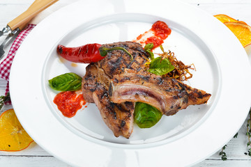 Grill a steak on the bone with chili. Dishes, food. Top view. Free space for your text.