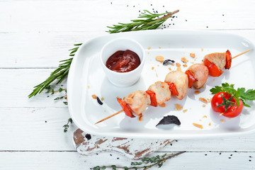 Chicken skewers with vegetables and sauce. Dishes, food. Top view. Free space for your text.