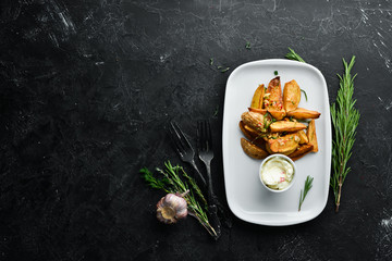 Baked potatoes with garlic and sauce. Dishes, food. Top view. Free space for your text.