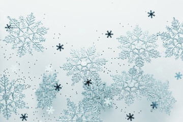 Festive winter background with decorative snowflakes in flying. Christmas, Winter or New Year...